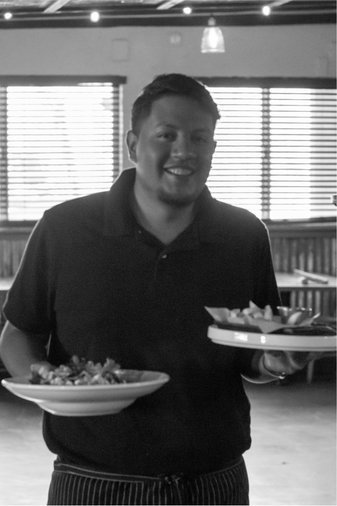 Black and white photo of Glossy Heifer Grill employee serving American cuisine, restaurant photography by Matthew Spaulding